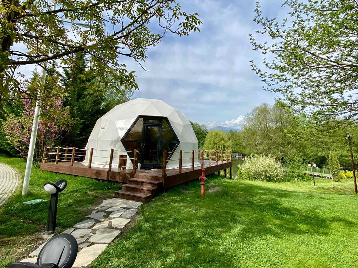 Geo-Dome M7MD on a wooden lakeside deck surrounded by trees