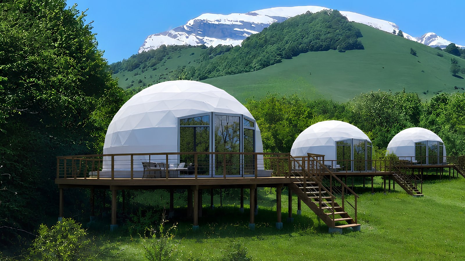 Geo-Dome 3D Panorama units in a green valley below snow-capped mountains